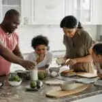 Function of Each Family Member for Primary 5 4 function of each family member: A joyful family enjoys preparing a healthy meal together in their modern kitchen.