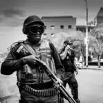 Second Term Examination on Security Education for JSS 1 3 grayscale photo of soldier carrying pump-action rifle