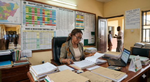 10 Practical School Management Tips for Nigerian School Heads & Owners 2 Nigerian school head managing school records and administrative tasks in an office setting.